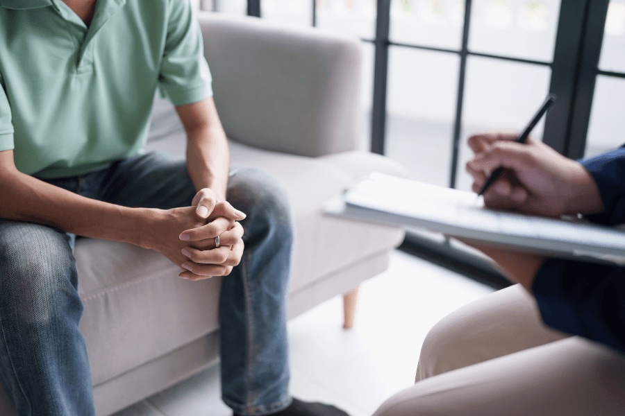 man talking with counselor at intake appointment