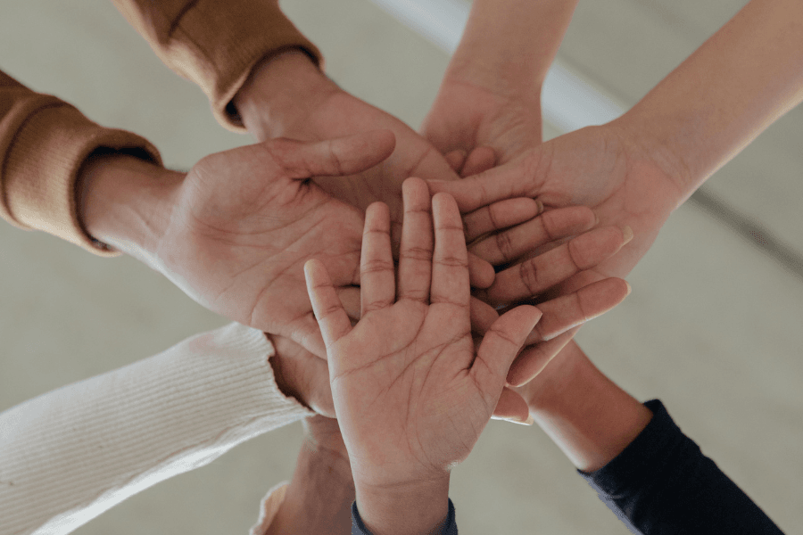 hands in a stack of collective support